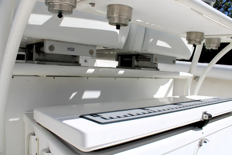 Slide: The Image of 2008 Edgewater 318CC boat detail showing fishing rod holders and storage compartments. - 21