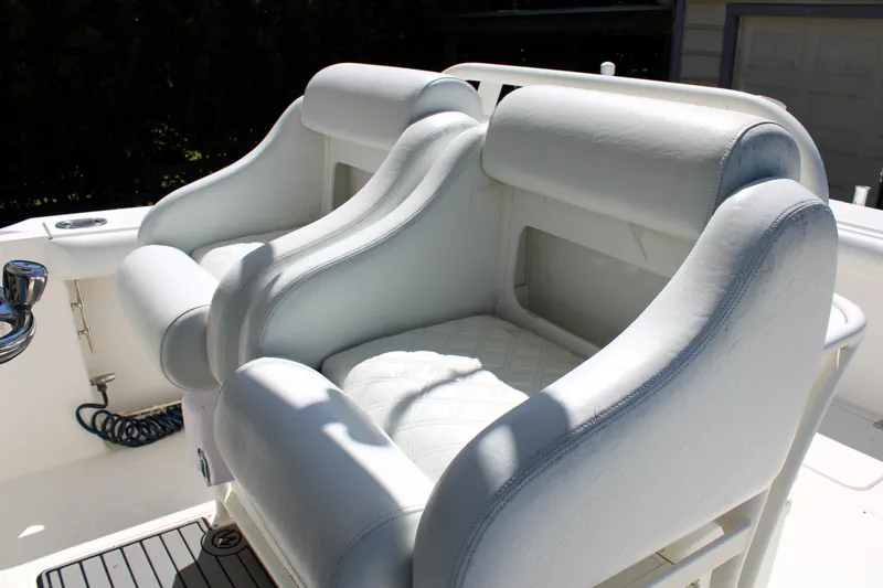 Slide: The Image of 2008 Edgewater 318CC boat with white cushioned seating in sunlight. - 22