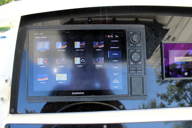 Slide: The Image of Garmin navigation system on 2008 Edgewater 318CC boat dashboard, displaying various control options. - 23