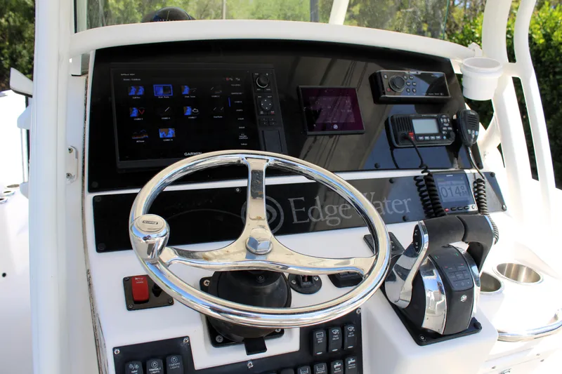 Slide: The Image of Edgewater 318CC 2008 boat dashboard with steering wheel and control panel. - 25