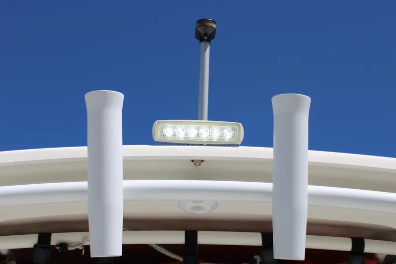 Slide: The Image of 2008 Edgewater 318CC boat with rod holders and LED light against clear blue sky. - 29