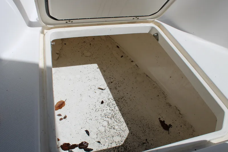Slide: The Image of Open storage compartment on 2008 Edgewater 318CC boat with debris inside. - 33