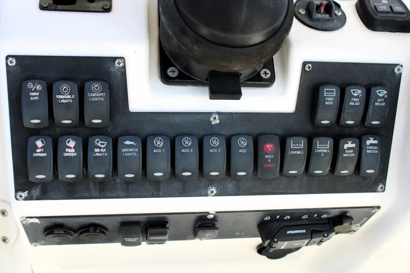 Slide: The Image of Control panel of a 2008 Edgewater 318CC boat with labeled switches and buttons. - 36