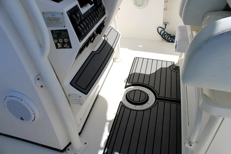 Slide: The Image of Interior of a 2008 Edgewater 318CC boat, featuring control panel and non-slip flooring. - 38