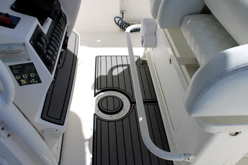 Slide: The Image of Interior view of a 2008 Edgewater 318CC boat, featuring seating and deck details. - 39
