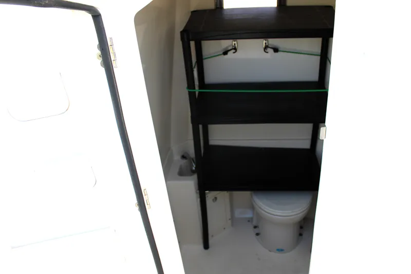 Slide: The Image of 2008 Edgewater 318CC boat interior with shelves and toilet. - 40