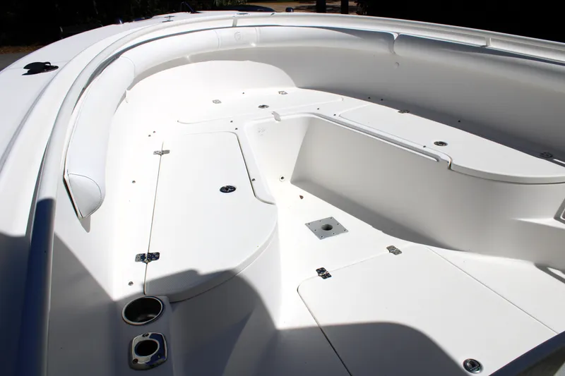 Slide: The Image of 2008 Edgewater 318CC boat interior, featuring a spacious white deck with storage compartments. - 42