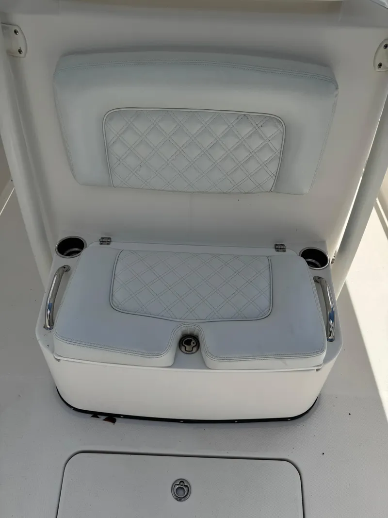 Slide: The Image of 2008 Edgewater 318CC boat seat with diamond-patterned upholstery and cup holders. - 43