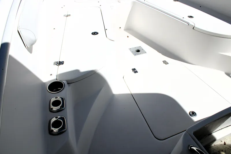 Slide: The Image of 2008 Edgewater 318CC boat deck with rod holders and storage compartments. - 44