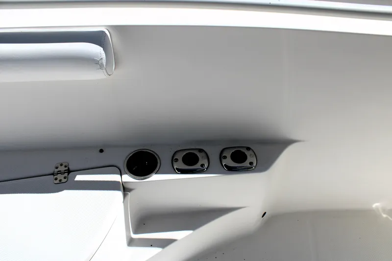 Slide: The Image of 2008 Edgewater 318CC boat interior with rod holders and storage compartment. - 45