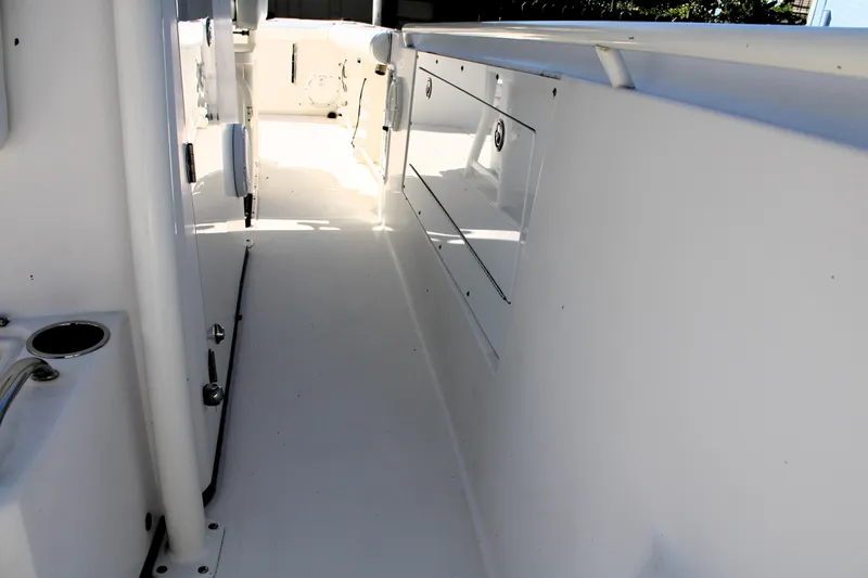 Slide: The Image of 2008 Edgewater 318CC boat interior, featuring sleek white design and storage compartments. - 46
