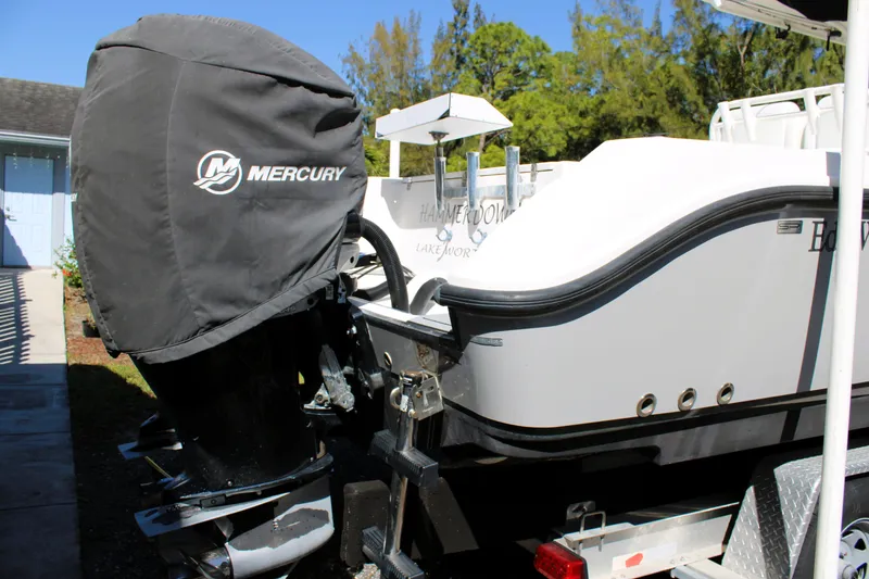 Slide: The Image of 2008 Edgewater 318CC boat with Mercury engine cover, parked on a trailer. - 7