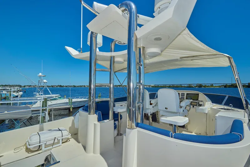 Slide: The Image of 2003 McKinna 58 Pilothouse yacht with sleek design and spacious deck, docked at marina. - 13