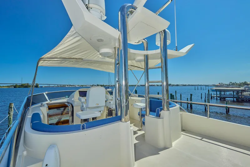 Slide: The Image of 2003 McKinna 58 Pilothouse yacht deck with seating, chrome details, and ocean view. - 14