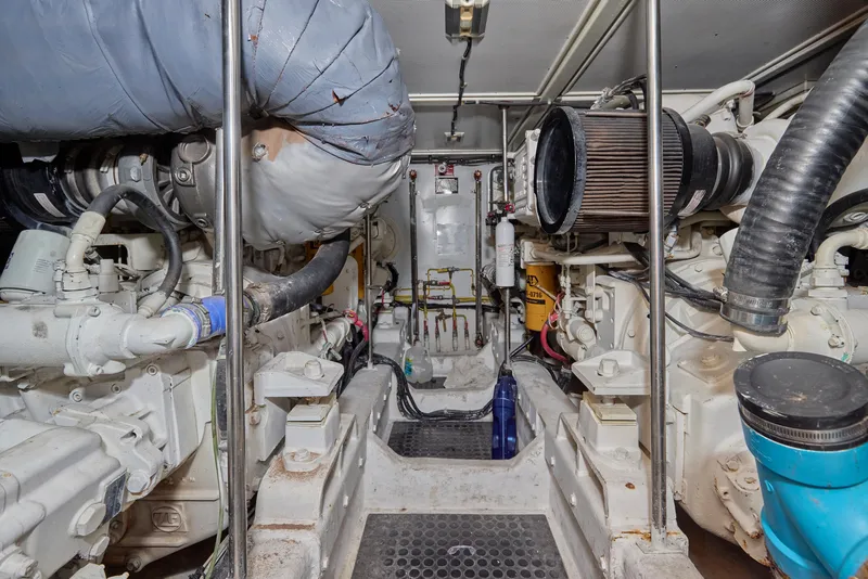 Slide: The Image of Engine room of a 2003 McKinna 58 Pilothouse yacht, showcasing mechanical components. - 18