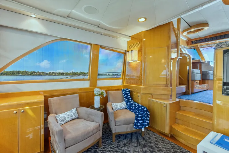 Slide: The Image of Luxurious interior of 2003 McKinna 58 Pilothouse yacht with plush seating and scenic windows. - 21