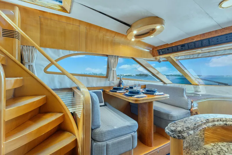 Slide: The Image of Luxurious interior of 2003 McKinna 58 Pilothouse yacht with elegant dining area and ocean view. - 23