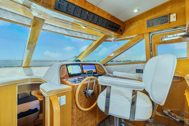 Slide: The Image of Pilothouse interior of 2003 McKinna 58, featuring helm station and panoramic windows. - 26