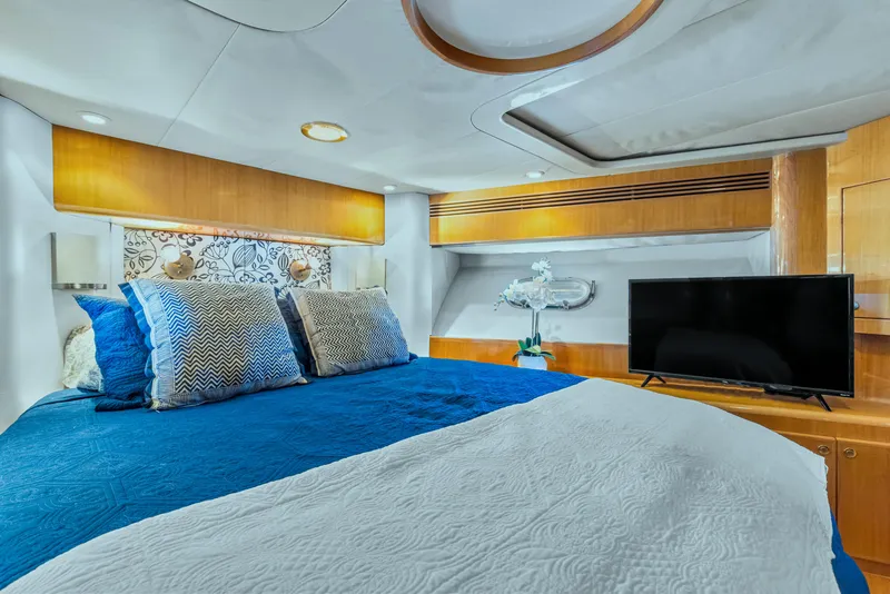 Slide: The Image of Luxurious bedroom in 2003 McKinna 58 Pilothouse yacht with modern decor and TV. - 27