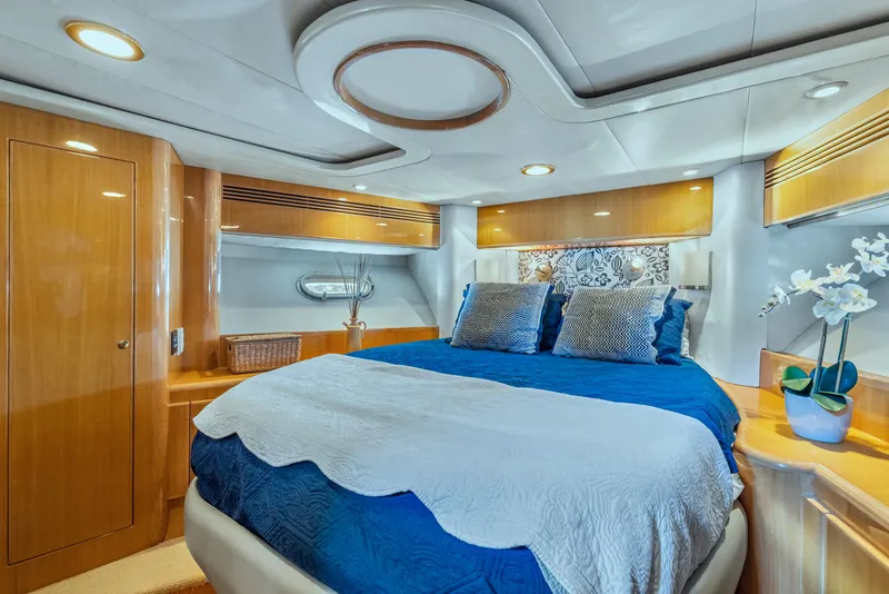 Slide: The Image of Luxurious bedroom interior of 2003 McKinna 58 Pilothouse yacht with elegant bedding and wood finishes. - 29
