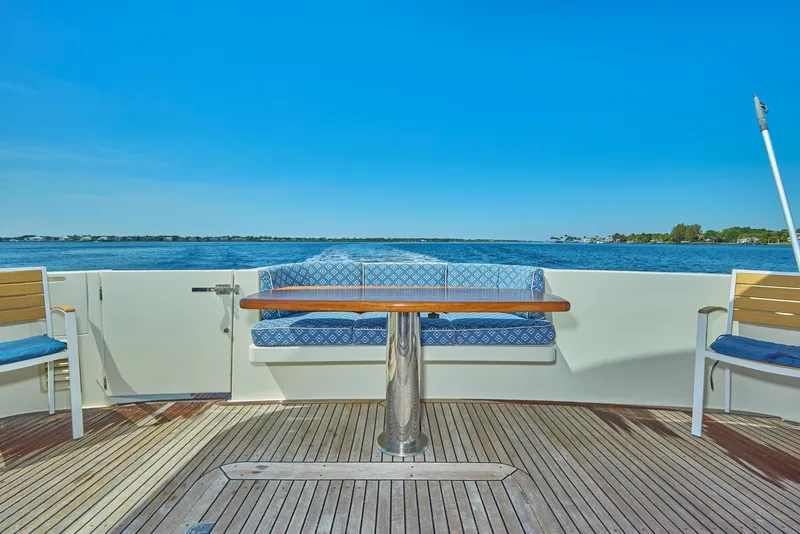 Slide: The Image of 2003 McKinna 58 Pilothouse yacht deck with seating and ocean view. - 3