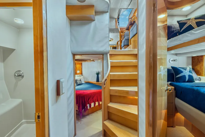 Slide: The Image of Luxurious interior of 2003 McKinna 58 Pilothouse yacht with cozy bedrooms and elegant wooden stairs. - 31
