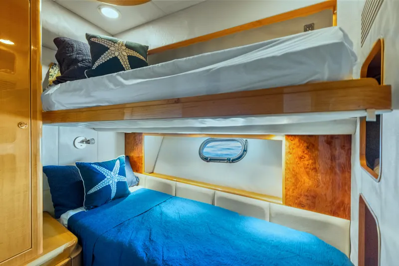 Slide: The Image of Bunk beds in 2003 McKinna 58 Pilothouse, featuring blue starfish-themed bedding. - 36