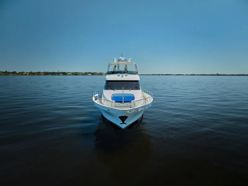 Slide: The Image of 2003 McKinna 58 Pilothouse yacht on calm water under clear blue sky. - 37