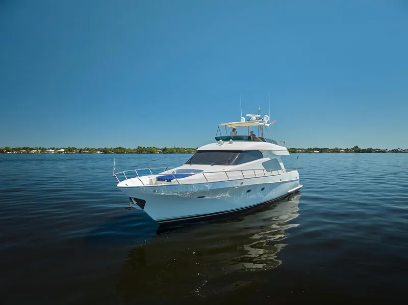Slide: The Image of 2003 McKinna 58 Pilothouse yacht on calm water under clear blue sky. - 39