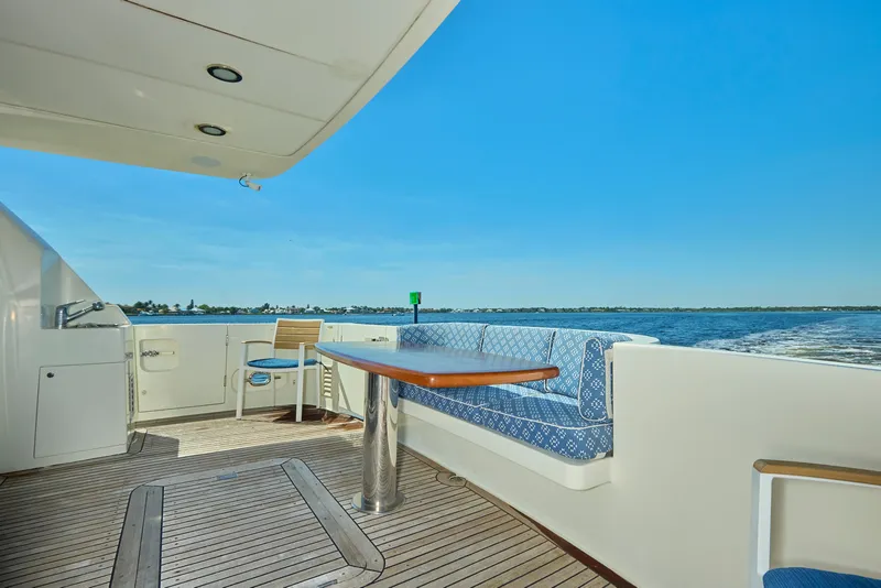 Slide: The Image of 2003 McKinna 58 Pilothouse yacht deck with seating, table, and ocean view. - 4