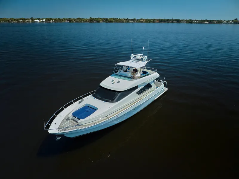 Slide: The Image of 2003 McKinna 58 Pilothouse yacht cruising on calm waters under clear blue skies. - 40