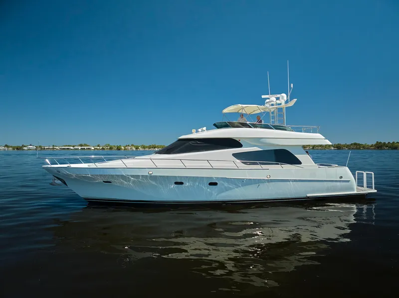 Slide: The Image of 2003 McKinna 58 Pilothouse yacht on calm water under clear blue sky. - 41