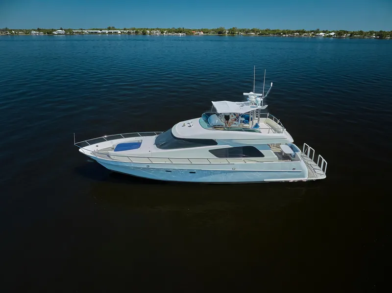 Slide: The Image of 2003 McKinna 58 Pilothouse yacht cruising on calm waters under clear skies. - 42