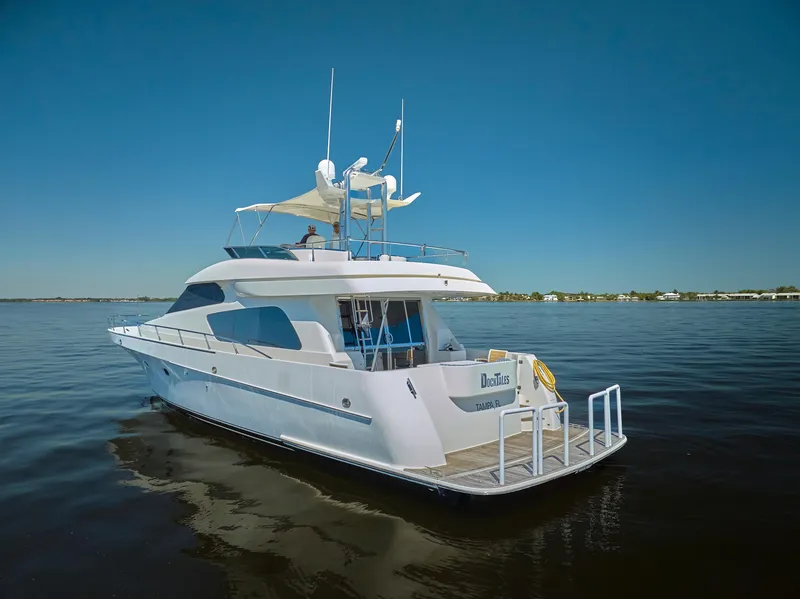 Slide: The Image of 2003 McKinna 58 Pilothouse yacht cruising on calm waters under clear blue skies. - 43