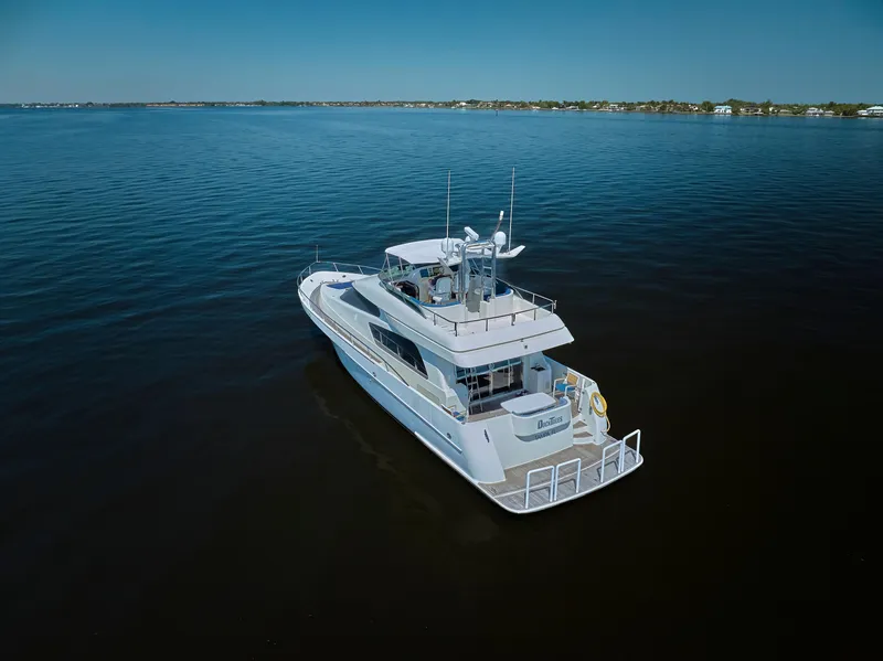 Slide: The Image of 2003 McKinna 58 Pilothouse yacht cruising on calm waters under clear skies. - 44