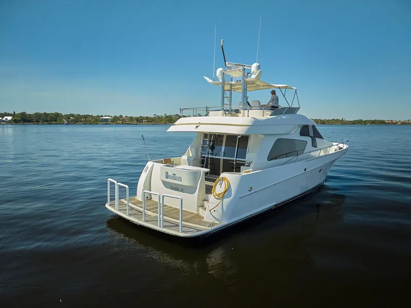 Slide: The Image of 2003 McKinna 58 Pilothouse yacht on calm water under clear blue sky. - 47