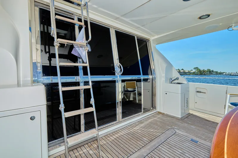Slide: The Image of 2003 McKinna 58 Pilothouse yacht deck with ladder and ocean view. - 5