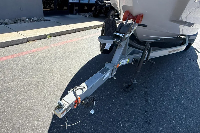 Slide: The Image of Trailer hitch of a 2025 MasterCraft NXT23 boat on pavement. - 10