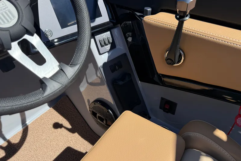 Slide: The Image of 2025 MasterCraft NXT23 boat interior with steering wheel and control panel. - 15