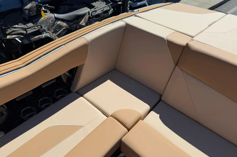 Slide: The Image of Beige and tan seating in 2025 MasterCraft NXT23 boat interior. - 18