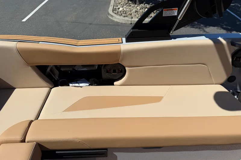 Slide: The Image of 2025 MasterCraft NXT23 boat interior with tan upholstery and sleek design. - 21