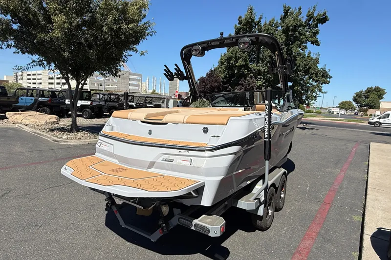 Slide: The Image of 2025 MasterCraft NXT23 boat on trailer in parking lot, rear view. - 7