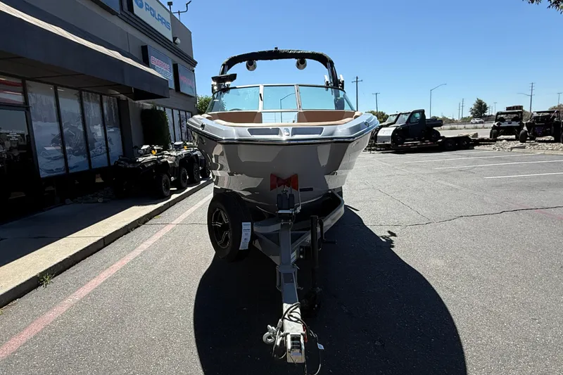 Slide: The Image of 2025 MasterCraft NXT23 boat on trailer in parking lot, front view. - 9