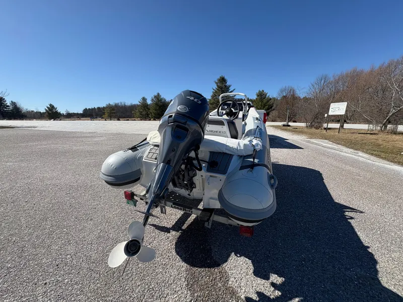 Slide: The Image of 2023 Highfield Sport 360 inflatable boat with outboard motor on a sunny day. - 10