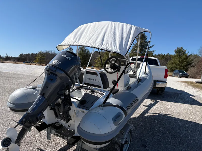 Slide: The Image of 2023 Highfield Sport 360 inflatable boat with canopy and outboard motor on trailer. - 14