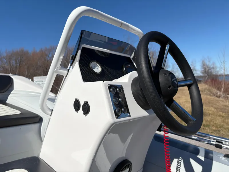Slide: The Image of 2023 Highfield Sport 360 boat console with steering wheel and controls. - 19