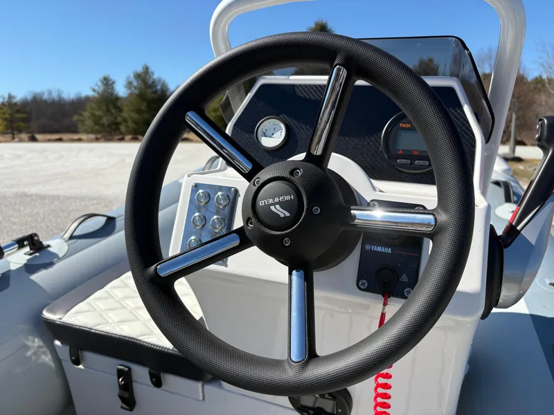Slide: The Image of 2023 Highfield Sport 360 boat steering wheel and dashboard, featuring Yamaha controls. - 21