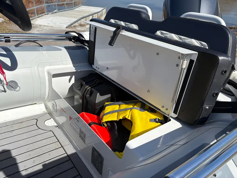 Slide: The Image of 2023 Highfield Sport 360 boat storage compartment with life jackets and gear. - 22