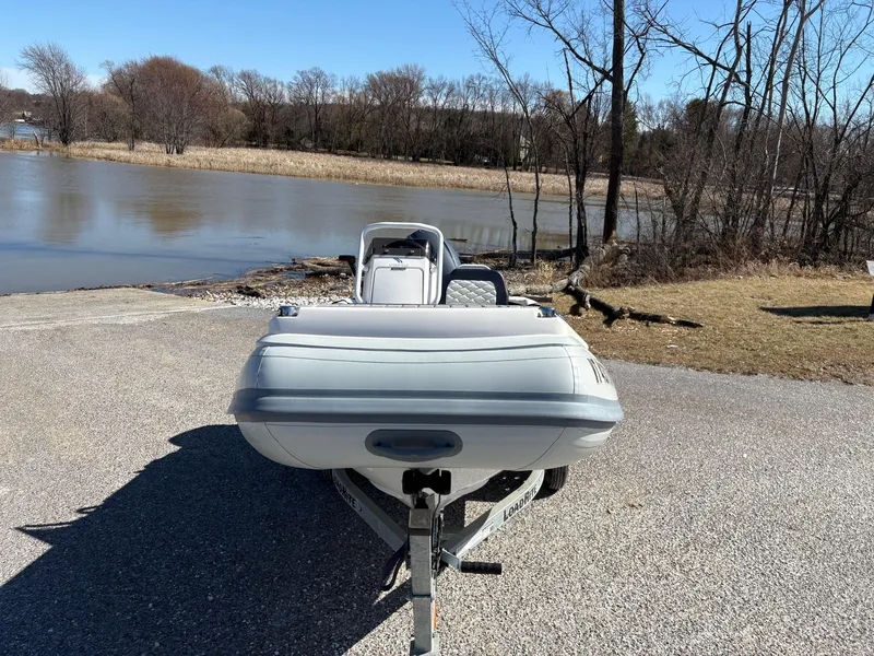 Slide: The Image of 2023 Highfield Sport 360 boat on trailer by a lake, clear sky, winter trees. - 5