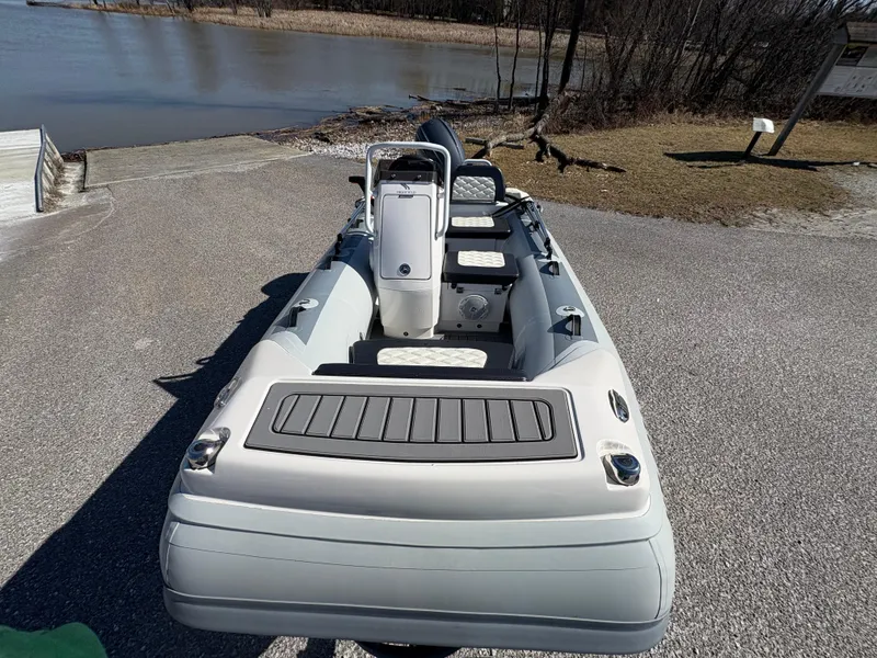 Slide: The Image of 2023 Highfield Sport 360 inflatable boat on a lakeside dock, ready for launch. - 8